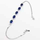 SILVER OVAL BLUE AND WHITE CUBIC ZIRCONIA HALO BRACELET